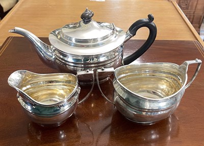 Lot 116 - A London silver three piece plain oval tea...