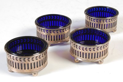 Lot 141 - A set of four Birmingham silver circular salt...