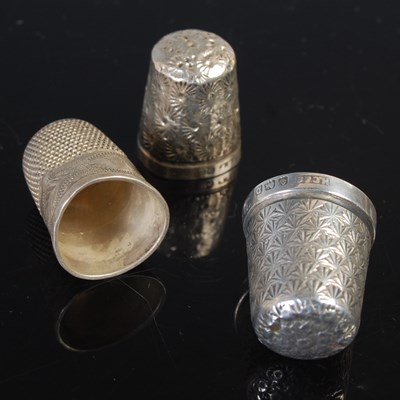 Lot 146 - Three engraved silver thimbles.
