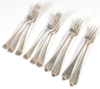 Lot 136 - Four George III silver dog-nose table forks,...