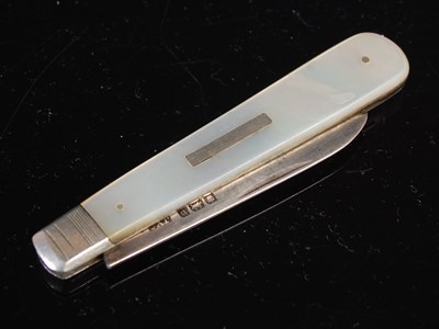 Lot 128 - A silver and mother of pearl folding pocket...