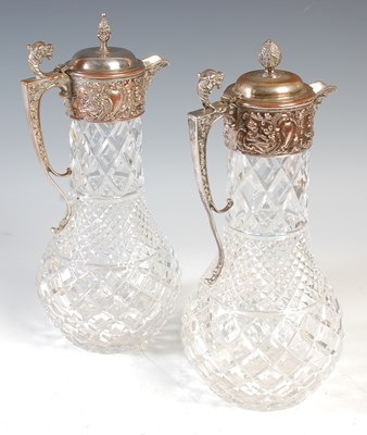 Lot 373 - A near pair of crystal claret jugs, featuring...