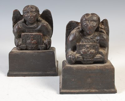 Lot 386 - A pair of carved oak sculptural book ends,...