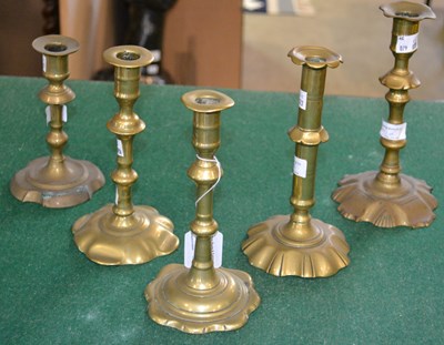 Lot 549 - Five single 18th century petal-based brass...