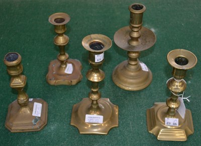 Lot 545 - Four single 18th century brass candlesticks...