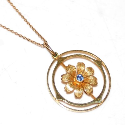 Lot 22 - A 9ct gold necklace suspending a yellow metal...