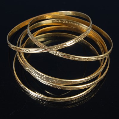 Lot 25 - Six high carat gold bangles, all stamped '22',...