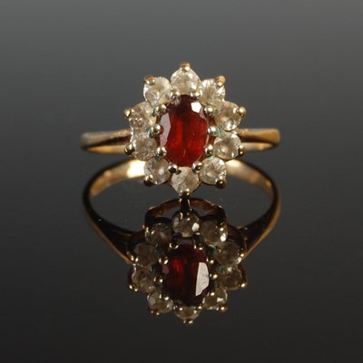 Lot 53 - A 9ct gold garnet and diamond cluster ring,...