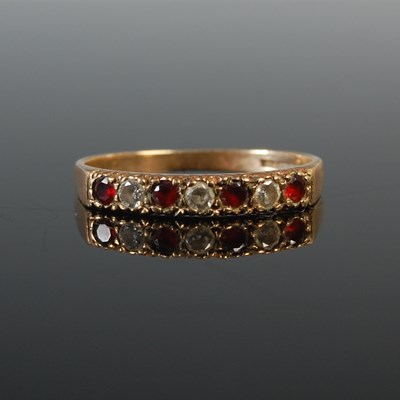 Lot 63 - A 9ct gold garnet and diamond seven stone half...
