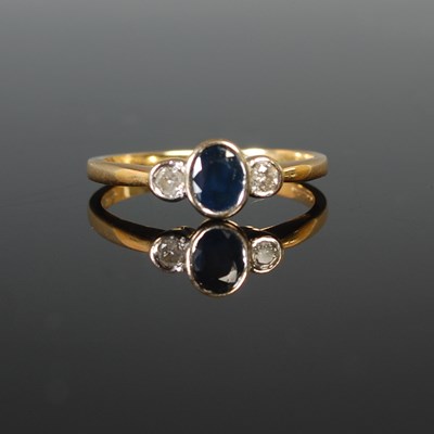 Lot 73 - An 18ct gold sapphire and diamond three stone...