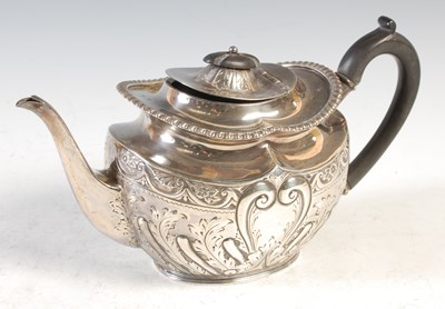 Lot 174 - A Sheffield silver teapot, embossed with...