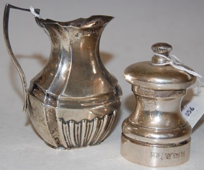 Lot 134 - A Birmingham silver milk / cream jug with part...