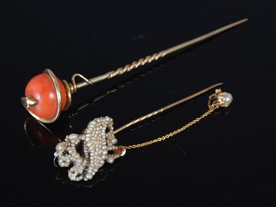 Lot 221 - A yellow metal and coral stick pin, the coral...