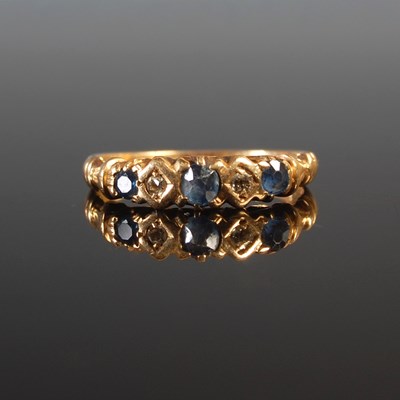 Lot 56 - A yellow metal sapphire and diamond five stone...