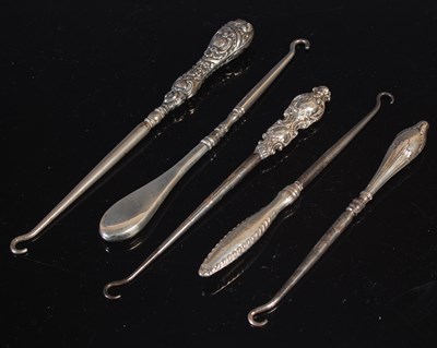 Lot 156 - A group of five assorted antique boot hooks,...