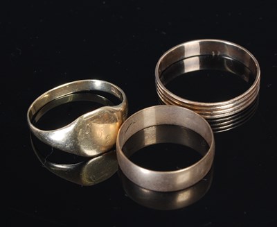 Lot 299 - Three yellow metal rings, two test as 9ct gold,...