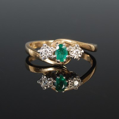 Lot 311 - A 9ct gold emerald and diamond three stone...