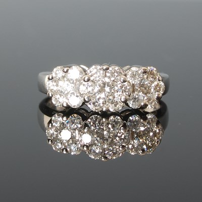 Lot 320 - A white metal and diamond set triple cluster...