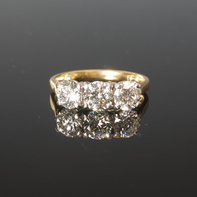 Lot 323 - An 18ct yellow and white gold three stone...