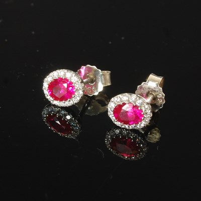 Lot 332 - A pair of white metal ruby and diamond cluster...