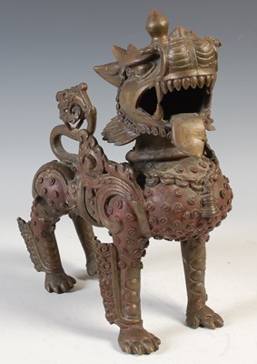 Lot 514 - A Chinese bronze figure of a Kylin / Foo dog,...
