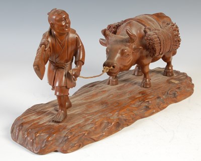 Lot 498 - A Japanese carved wood figure group of farmer...
