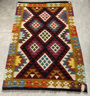 Lot 930 - A Maimana Kilim rug, worked in burgundy, ochre,...