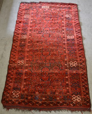 Lot 935 - A Persian rug, the rectangular madder ground...
