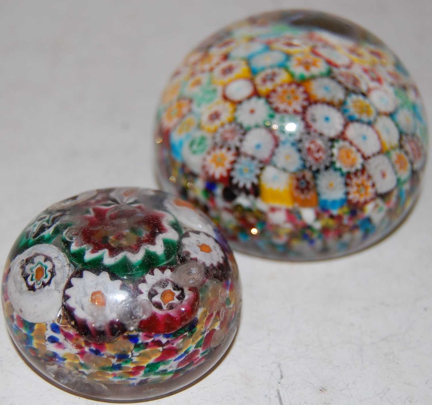 Lot 179 - A colourful millefiori ground paperweight,...