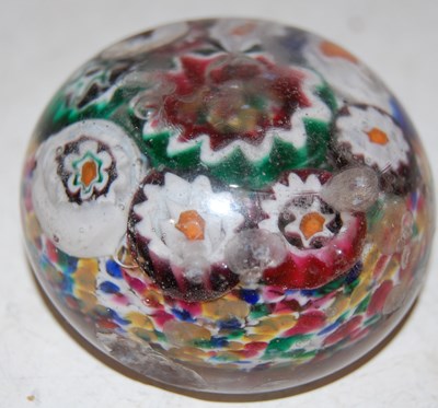 Lot 179 - A colourful millefiori ground paperweight,...