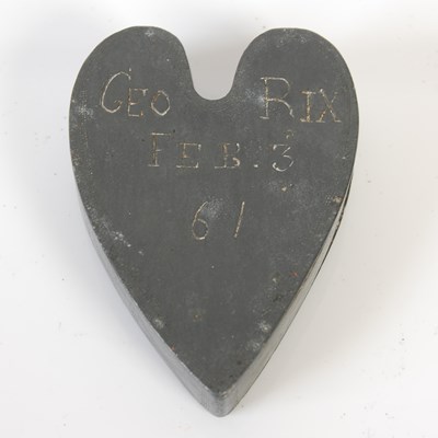 Lot 247 - An unusual heart-shaped pewter snuff box, the...