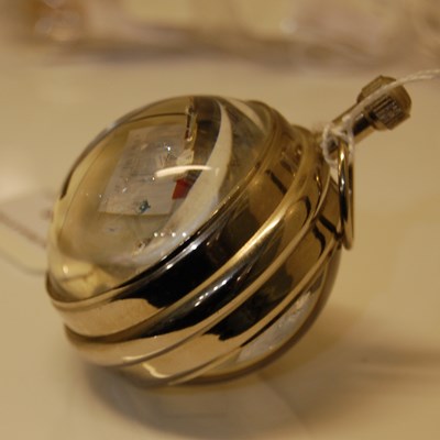 Lot 228 - A chrome mounted glass ball clock with black...