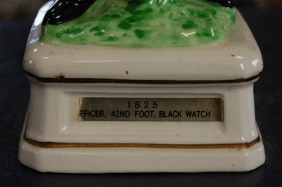 Lot 455 - A ceramic figure group of a 1825 Officer of...