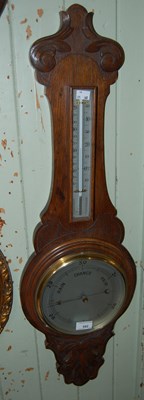 Lot 592 - A carved oak mercury filled barometer