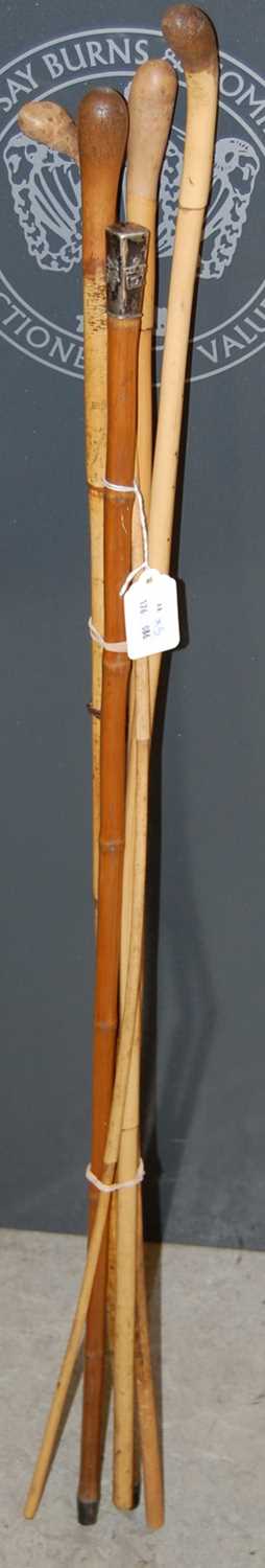 Lot 527 - A white metal mounted bamboo walking cane, the...