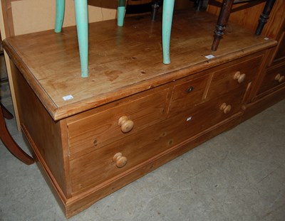 Lot 751 - A pine low chest of three short and one long...