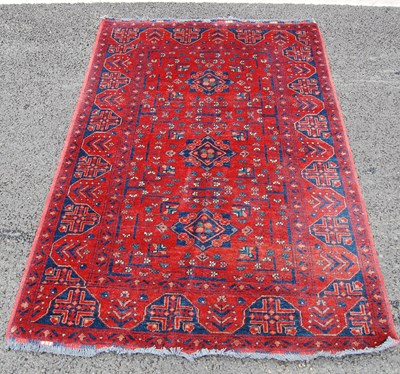 Lot 808 - A Persian rug, the madder ground centred with...
