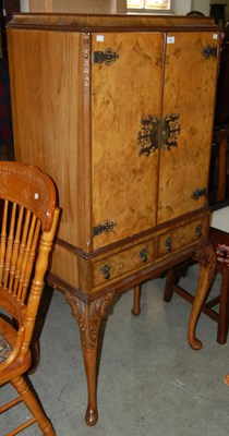 Lot 687 - A walnut drinks cabinet, two cupboard doors...