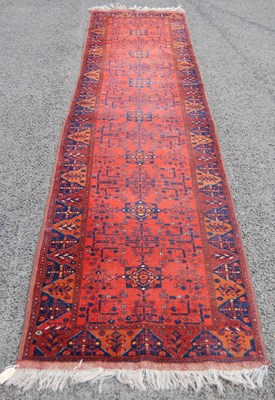 Lot 811 - A Persian runner, the madder ground centred...