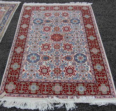 Lot 814 - A white ground Persian rug, the rectangular...