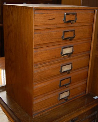 Lot 636 - A vintage blondewood table top chest of six...