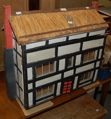 Lot 642 - A dolls house, modelled on a Tudor mansion...
