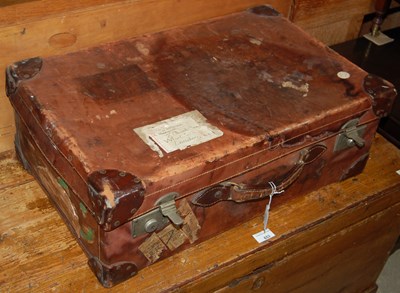 Lot 652 - A vintage leather covered suitcase