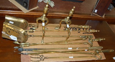 Lot 657 - A collection of brass fire irons and a pair of...