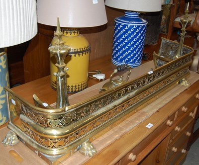Lot 703 - A 19th century fret-cut brass fender with...