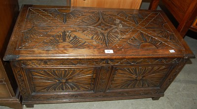 Lot 715 - A carved oak blanket box