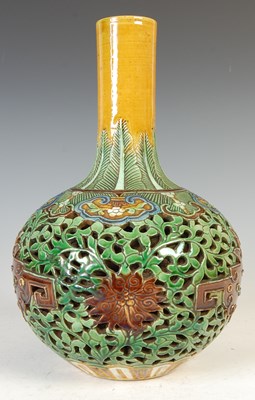 Lot 688 - A Chinese porcelain sancai glazed reticulated double-wall bottle vase, Qing Dynasty