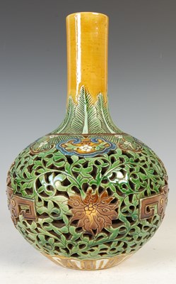 Lot 688 - A Chinese porcelain sancai glazed reticulated double-wall bottle vase, Qing Dynasty