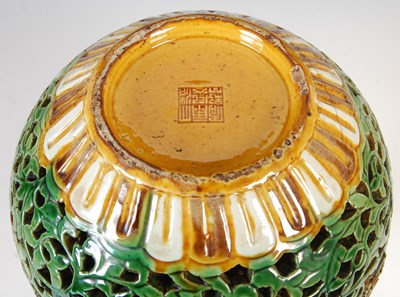 Lot 688 - A Chinese porcelain sancai glazed reticulated double-wall bottle vase, Qing Dynasty