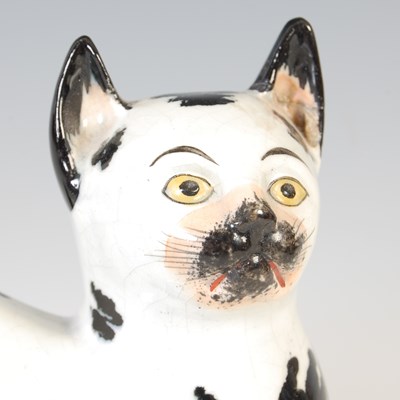 Lot 620 - A rare pair of 19th century Staffordshire pottery cats